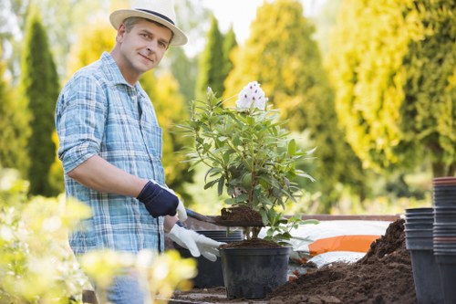Gardener pruning plants in a Seven Sisters garden